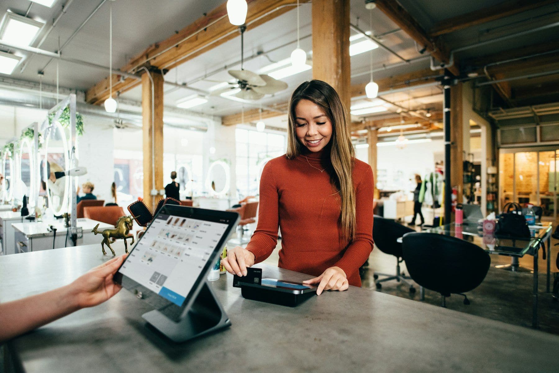 Seller taking an order at the counter of their shop
