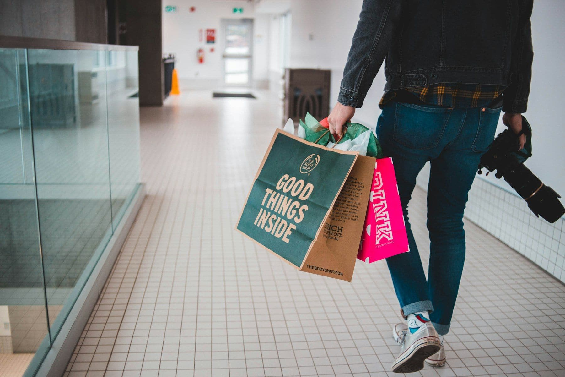 Customer walking through a retail centre with purchases